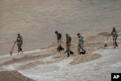 Indian army personnel continue the search for those missing along the Teesta river in Bardang, east Sikkim, Oct. 8. 2023.