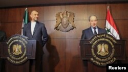 Syrian Foreign Minister Faisal Mekdad, right, speaks during a joint news conference with Iranian Foreign Minister Hossein Amirabdollahian in Damascus, Syria, March 9, 2023. 
