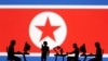 북한 인공기와 컴퓨터를 사용하는 사람들 일러스트. (자료사진)