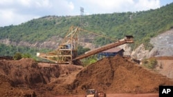 FILE - Equipment sits idle in the nickel mine run by the Swiss-based Solway Investment Group next to Izabal Lake in El Estor in the northern coastal province of Izabal, Guatemala, Oct. 26, 2021.