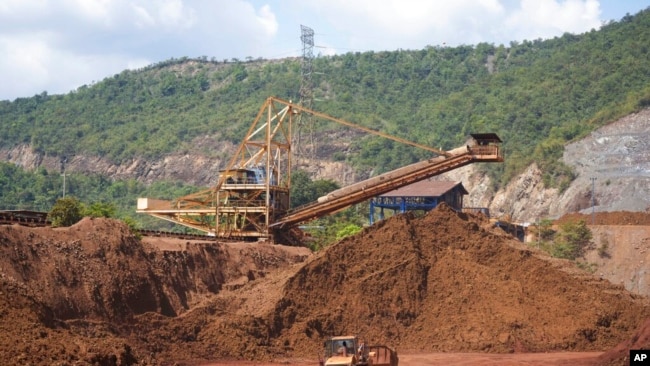 FILE - Equipment sits idle in the nickel mine run by the Swiss-based Solway Investment Group next to Izabal Lake in El Estor in the northern coastal province of Izabal, Guatemala, Oct. 26, 2021.