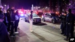 Students get directions from police on the campus of Michigan State University after a shelter in place order was lifted early Tuesday, Feb. 14, 2023, in East Lansing, Michigan. (AP Photo/Al Goldis)