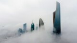 This aerial picture shows highrise buildings during a foggy morning in Kuwait City, March 14, 2023. 
