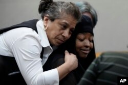 Whitney Mitchell, right, receives a hug from a friend as she attends a sentencing hearing for U.S. Army Sgt. Daniel Perry, who was convicted of murder for fatally shooting her boyfriend, Garrett Foster, in 2020, in Austin, Texas, May 9, 2023.