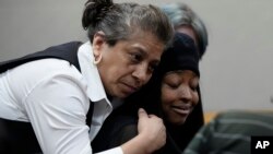 FILE: Whitney Mitchell, right, receives a hug from a friend as she attends a sentencing hearing for U.S. Army Sgt. Daniel Perry, who was convicted of murder for fatally shooting her fiance, Garrett Foster, in 2020, in Austin, Texas. Taken Tues. May 9, 2023.