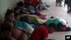 Venezuelan migrants take cover from the rain near the banks of the Rio Grande in Matamoros, Mexico, May 13, 2023.