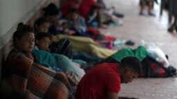 Venezuelan migrants take cover from the rain near the banks of the Rio Grande in Matamoros, Mexico, May 13, 2023.