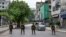 FILE - Bangladesh soldiers stand guard along the street in Dhaka on July 20, 2024, after days of protests against government job quotas across the country. Journalists report being harassed, forced to delete images from their cameras, and injured while covering the unrest.