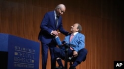 President Joe Biden and civil rights activist Andrew Young attend an event marking the 60th anniversary of the Civil Rights Act, July 29, 2024, at the LBJ Presidential Library in Austin, Texas.