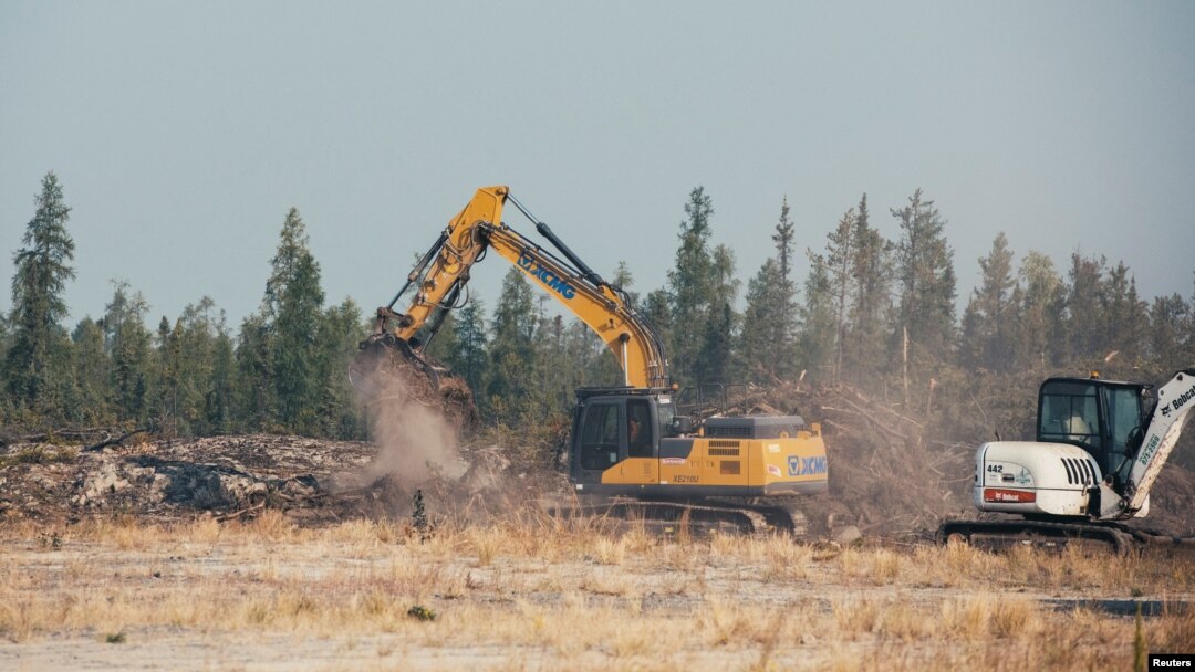 Workers clear trees to create a fire break near Yellowknife after a state of emergency was declared due to the proximity of a wildfire, in Yellowknife, Northwest Territories, Canada, Aug. 16, 2023.