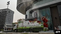 A cannon sprays water outside a shopping mall amid high levels of air pollution in Chiang Mai in northern Thailand on March 10, 2023.