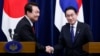 FILE - South Korea President Yoon Suk Yeol, left, and Japan Prime Minister Fumio Kishida shake hands during a joint news conference in Tokyo, March 16, 2023. Kishida will see Yoon again when he visits Seoul on Sunday. 
