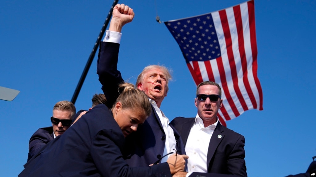 FILE - Republican presidential candidate former president Donald Trump is surrounded by U.S. Secret Service agents following an assassination attempt at a campaign rally, in Butler, Pennsylvania, July 13, 2024, in this image by AP journalist Evan Vucci.