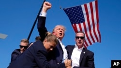 FILE - Republican presidential candidate former president Donald Trump is surrounded by U.S. Secret Service agents following an assassination attempt at a campaign rally, in Butler, Pennsylvania, July 13, 2024, in this image by AP journalist Evan Vucci.