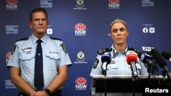 Australian Federal Police Deputy Commissioner Krissy Barrett along with NSW Police Deputy Commissioner David Hudson hold a news conference after a number of search warrants were executed in Sydney, April 24, 2024.