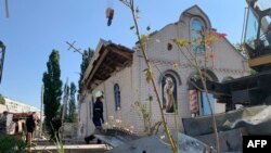 Rescuers work outside a destroyed church after a Russian missile strike in Zaporizhzhia, Aug. 10, 2023.