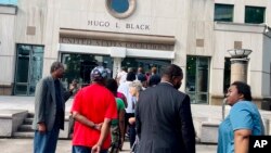 FILE - A line of people wait outside the federal courthouse in Birmingham, Alabama, Aug. 14, 2023, to watch a redistricting hearing. Federal judges said on Sept. 5, 2023, that the state legislature again discriminated against Black voters in drawing congressional district lines.
