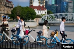 Beberapa pasangan bersiap untuk sesi pemotretan pernikahan di jalan, di Shanghai, China, 6 September 2023. (REUTERS/Aly Song)