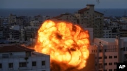 Fire and smoke rise following an Israeli airstrike in Gaza City, Oct. 8, 2023. 