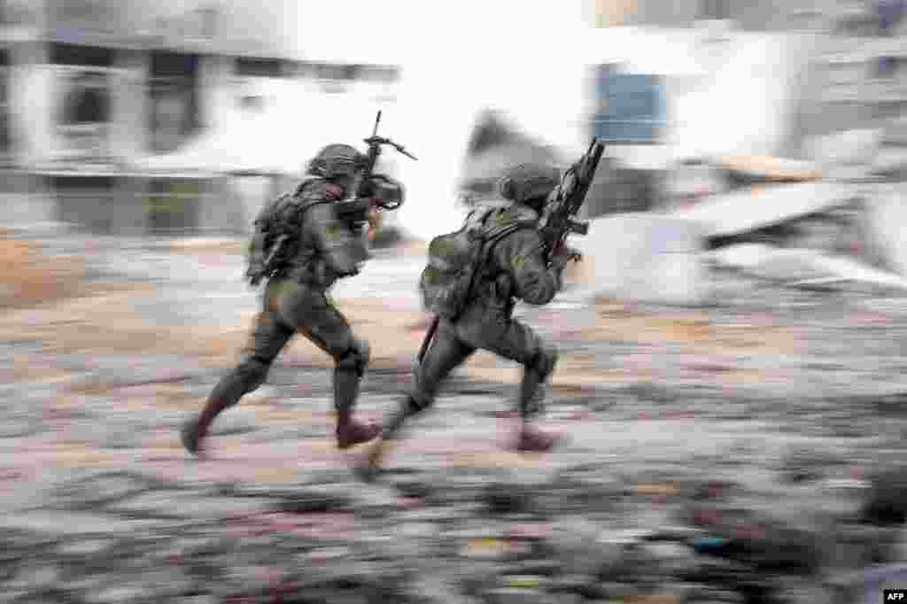 Israeli soldiers are seen during operations in the Gaza Strip amid the ongoing conflict between Israel and the Palestinian militant group Hamas, in this handout picture released by the Israeli Army.