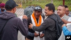 FILE- Veteran Sherpa guide Kami Rita returning after scaling Mount Everest for the 28th time arrives at the airport in Kathmandu, Nepal, May 25, 2023. 