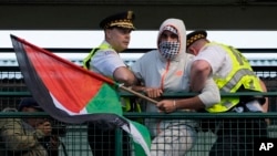 Police detain a protester during a demonstration outside the Democratic National Convention, Aug. 21, 2024, in Chicago. 