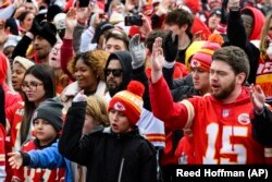Kansas City Chiefs fans do the tomahawk chop during the Chiefs' victory celebration in Kansas City, Mo., Wednesday, Feb. 15, 2023.