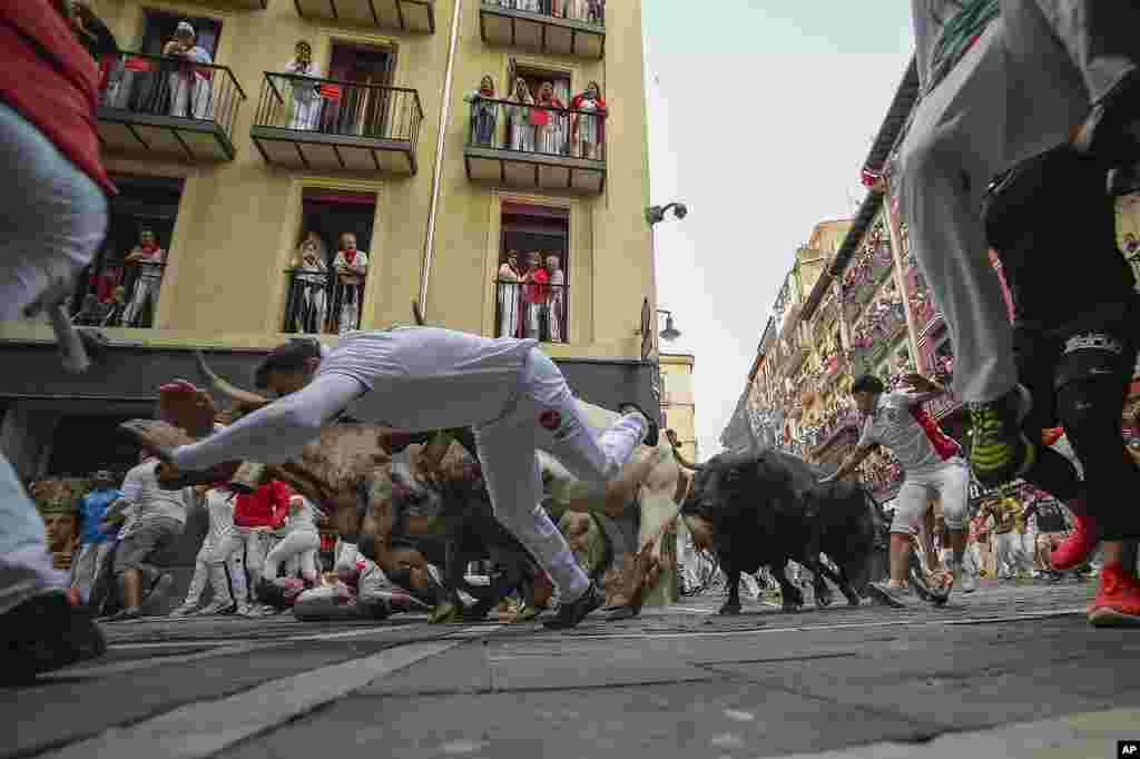 Revelers run with bulls from the Jandilla ranch during the sixth day of the running of the bulls at the San Fermín fiestas in Pamplona, Spain.