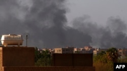 FILE: Smoke billows in the distance in Khartoum on May 22, 2023, as gunfire and explosions rocked Sudan's capital hours before a one-week humanitarian cease-fire was due to take effect, the latest after a series of truces that have all been violated.