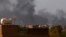 FILE: Smoke billows in the distance in Khartoum on May 22, 2023, as gunfire and explosions rocked Sudan's capital hours before a one-week humanitarian cease-fire was due to take effect, the latest after a series of truces that have all been violated.