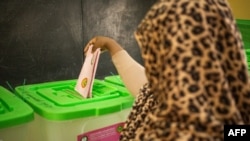 FILE - A woman casts her ballot at a polling station in Nouakchott on May 13, 2023. 