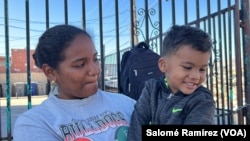 Diagnelis Martínez y su hijo de tres años, Santiago, a las afueras de un refugio en El Paso, Texas, donde duermen junto a otros migrantes el 8 de mayo de 2023. La mujer, su esposo y el menor, llegaron desde Venezuela tras ocho meses de travesía terrestre.