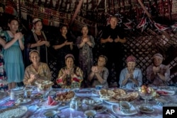 Residents of Shege village pray for the revival of the Aral Sea near Muynak, Uzbekistan, July 12, 2023.