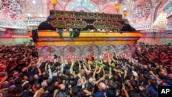 Shiite Muslims participate in the Arbaeen pilgrimage in Karbala, Iraq, Aug. 25, 2024. 