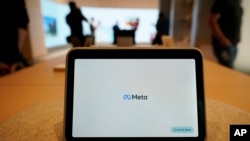 FILE - A Meta Portal Go is displayed at a Meta Store in Burlingame, Calif., May 4, 2022. There has been a marked rise in sextortion cases in recent years, fueled in part by a loosely organized group called the Yahoo Boys, operating mainly out of Nigeria, Meta said. 