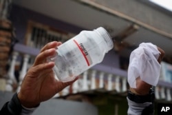 A worker releases mosquitoes infected with bacteria to stop dengue in Tegucigalpa, Honduras, Aug. 24, 2023. (AP Photo/Elmer Martinez)