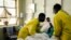 FILE - Nurses attend to a patient lying on a hospital bed in a medical ward at a local hospital in Harare, Zimbabwe, April 26, 2022.