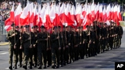 Members of the new voluntary Territorial Defense Troops march with Poland's national flags in a massive military parade in Warsaw, Poland, Aug. 15, 2023