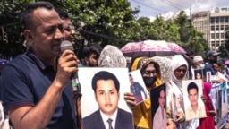 Carrying photos of relatives who have allegedly become victims of enforced disappearance, people take part in a silent rally in Dhaka, Bangladesh, on Aug. 30, 2022. (Photo by Abdur Rajjak for VOA)