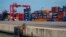 FILE - Containers are stacked up at the Port of Cotonou in Benin, May 28, 2019. A Millennium Challenge Corporation grant crafted in 2023 will focus on reducing transportation costs between the port and Niamey, Niger.