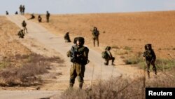 Israeli soldiers patrol near Israel's border with the Gaza Strip, in southern Israel, Oct. 19, 2023. 
