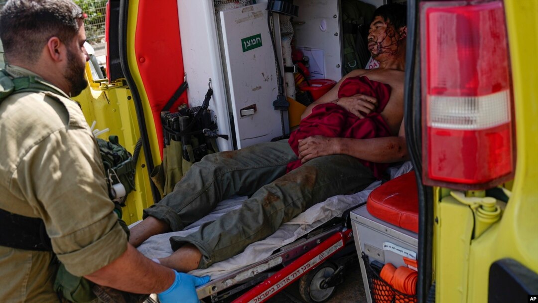 Israeli security forces in Kiryat Shoma, northern Israel, evacuate a wounded Thai man after he was hit by an anti-tank missile fired from Lebanon, in a nearby village on March 4, 2024.