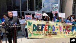 FILE - Demonstrators gather at a rally outside the federal courthouse following a hearing on the fate of a revised version of the Deferred Action for Childhood Arrivals, or DACA, program, in Houston, June 1, 2023.