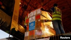 Aid supplies from World Health Organization (WHO) and UAE-AID are loaded into a plane for Port Sudan, at the Abu Dhabi International Airport, Abu Dhabi, United Arab Emirates, May 5, 2023. 