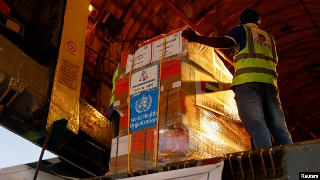 FILE - Aid supplies from World Health Organization (WHO) and UAE-AID are loaded into a plane for Port Sudan, at the Abu Dhabi International Airport, Abu Dhabi, United Arab Emirates, May 5, 2023.