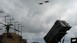 The Ukrainian Air Force's F-16 fighter jets fly over a Patriot Air and Missile Defense System in an undisclosed location in Ukraine, Aug. 4, 2024. 