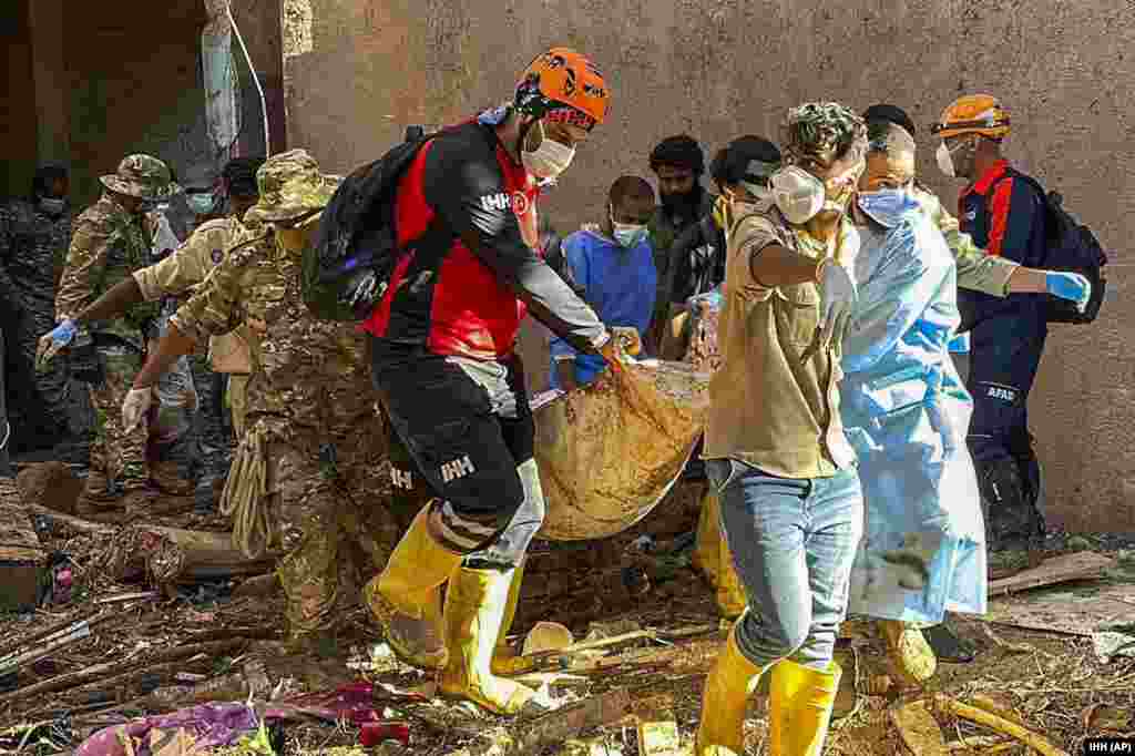 In this photo provided by Turkey&#39;s IHH humanitarian aid group, rescuers retrieve the body of a flooding victim in Derna, Sept.13, 2023.