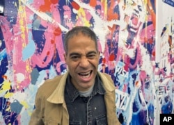 Street artist JonOne poses in front of his artwork at the Palais-Royal Station, during the 2024 Paris Olympics, July 31, 2024 in Paris.