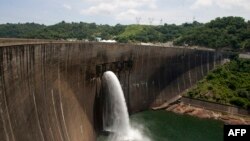 Kariba Dam wall between Zimbabwe and Zambia where hydropower is generated for both nations.