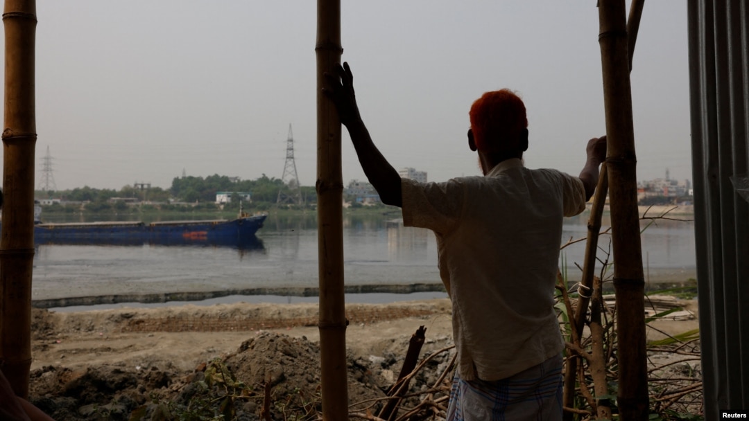 FILE - Nurul Islam, 70, looks over the Buriganga River, where he used to fish, in Dhaka, Bangladesh, March 18, 2023.